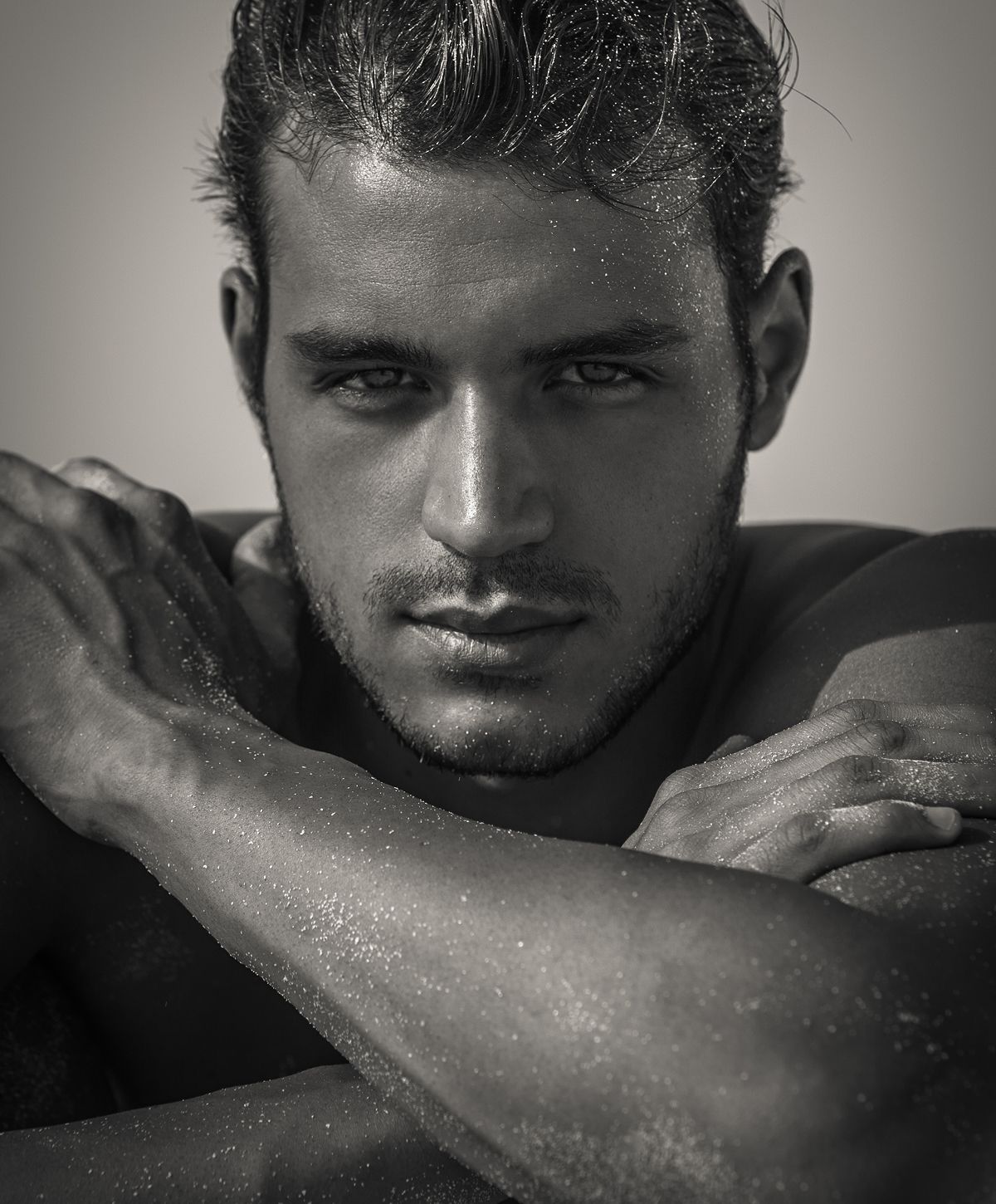 Black and white portrait of a man with sand.