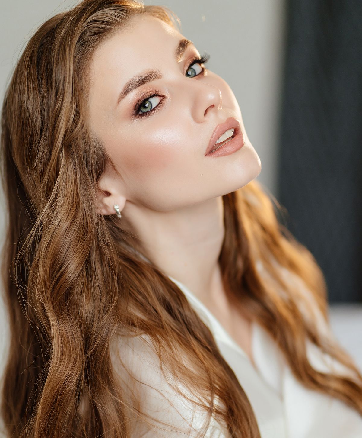 Woman with long hair and natural makeup.