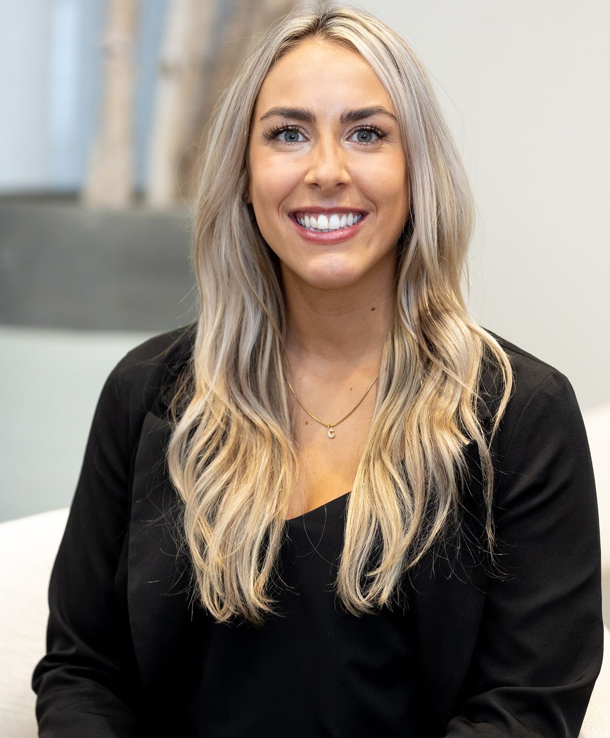 Smiling woman with long blonde hair in black.