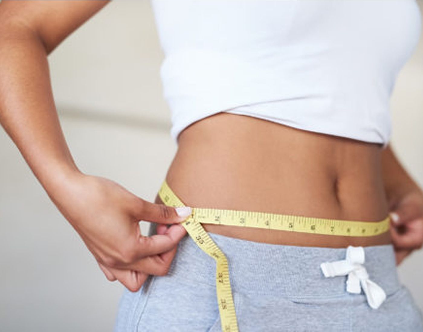 Measuring waist circumference with a tape measure.