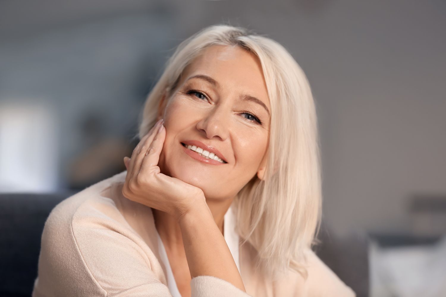 Woman with an elegant hairstyle and neutral expression.