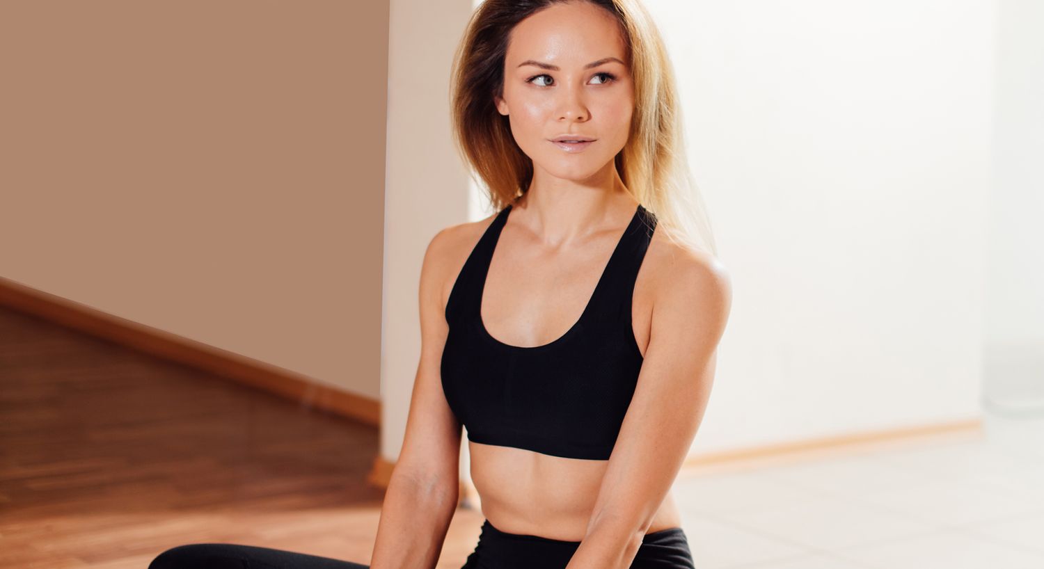 Woman in athletic wear posing indoors.
