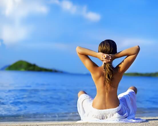 female meditating at beach