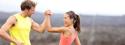 athletic man and woman high fiving