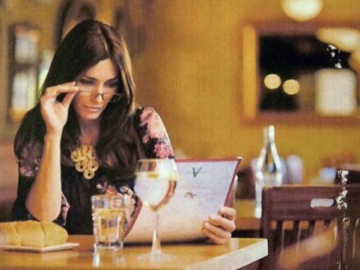 woman using glasses to read a menu