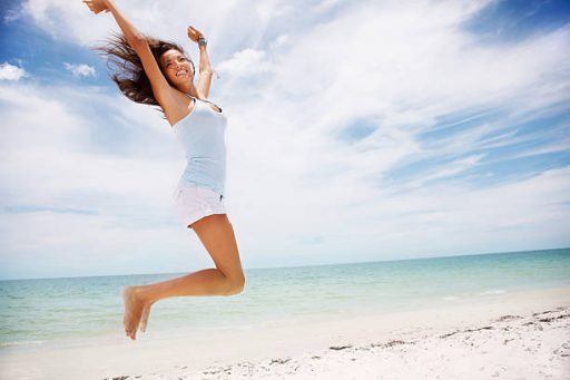 woman jumping on beach